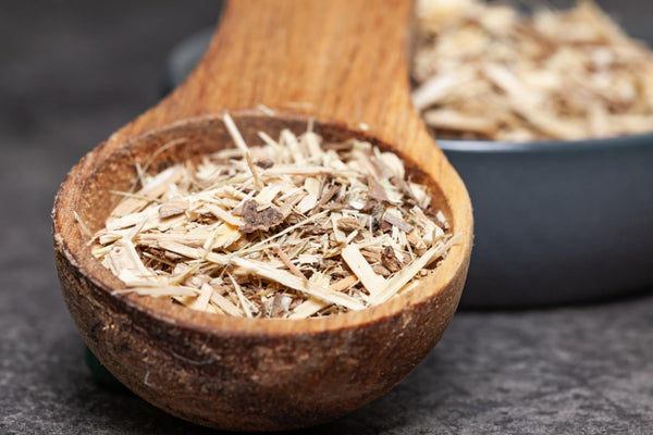 A wooden spoon with wood shavings